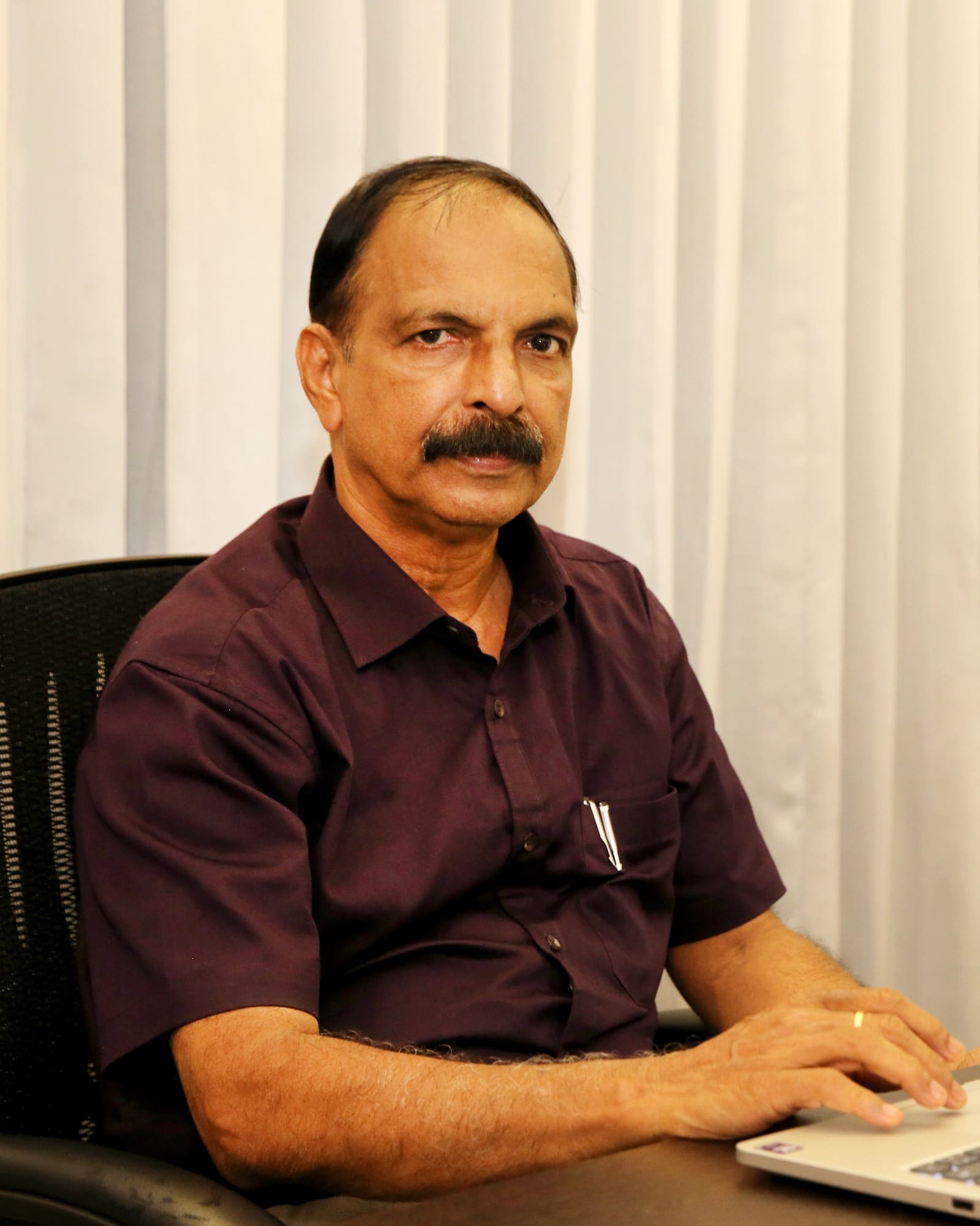 Dr V Pavithran, Chief Consultant Psychologist, at his desk at Parivartan